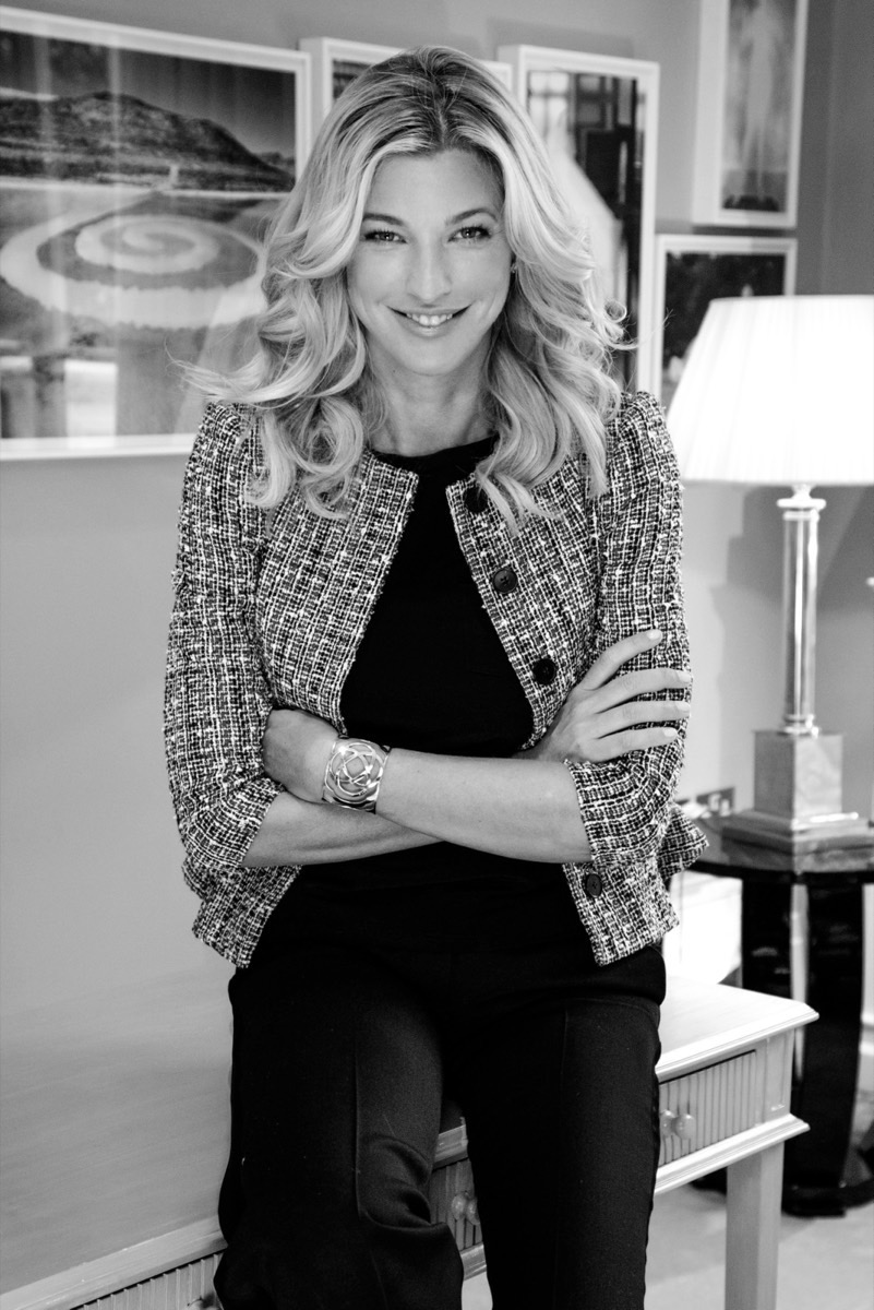 Nicole Junkermann in a tweed jacket, a striking black-and-white portrait