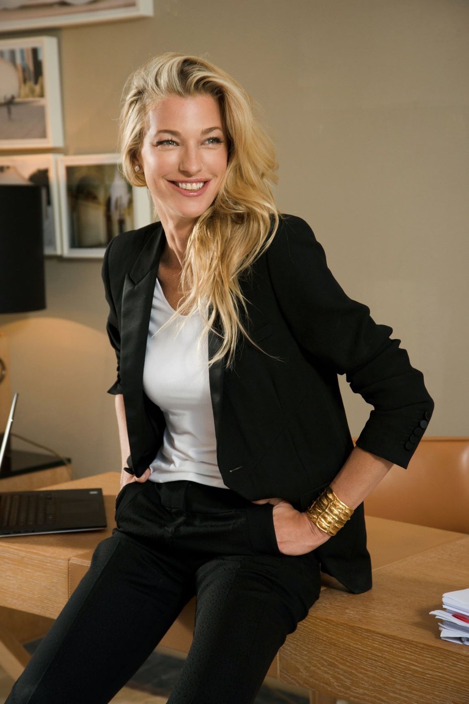 Nicole Junkermann smiling in a black blazer and white top in a bright office, a colour portrait